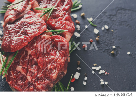 Rib eye steak and spices on wood at black Rib eye steak and spices on wood at black 34668714