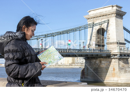 woman looks in the city map at the Szechenyi Chain Bridge woman looks in the city map at the Szechenyi Chain Bridge 34670470