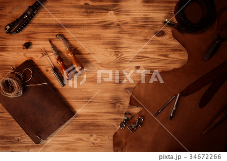 Leather craft. Tanner's tools on grey wooden Leather craft. Tanner's tools on grey wooden 34672266
