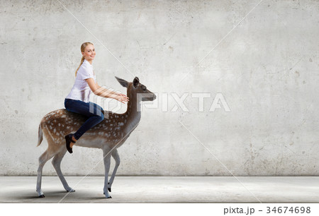 Woman ride deer 34674698