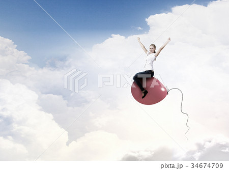 Woman riding balloon Woman riding balloon 34674709