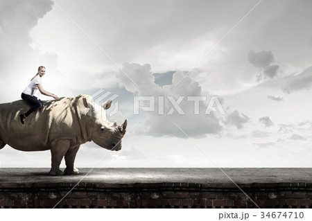 Woman ride rhino 34674710