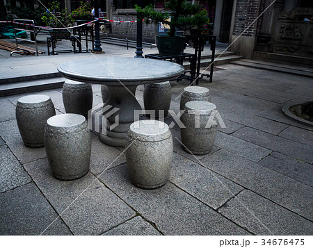 table and benches made of stone in the garden 34676475