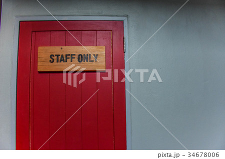 the red door with wood staff only sign on it. the red door with wood staff only sign on it. 34678006