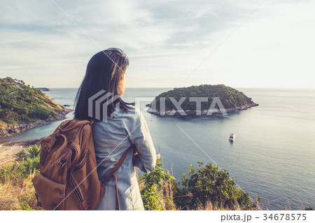 Young traveler woman standing at mountain 34678575
