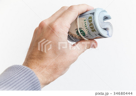 Roll of One Hundred Dollars in male hand isolated 34680444
