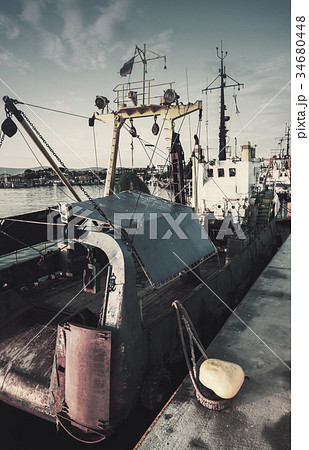 Industrial fishing boats are moored in port 34680448