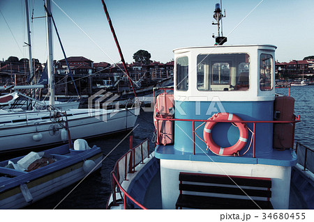 Fishing boats are moored in port 34680455