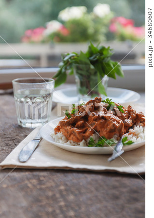 Dish rice with beef stroganoff on a white plate Dish rice with beef stroganoff on a white plate 34680607