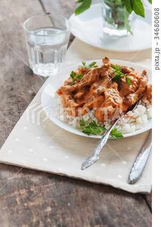 Dish rice with beef stroganoff on a white plate Dish rice with beef stroganoff on a white plate 34680608