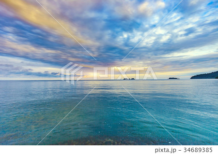 Beautiful sunrise at the shore with cloudy sky 34689385