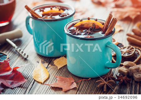 Mulled wine in blue mugs with spices. 34692096