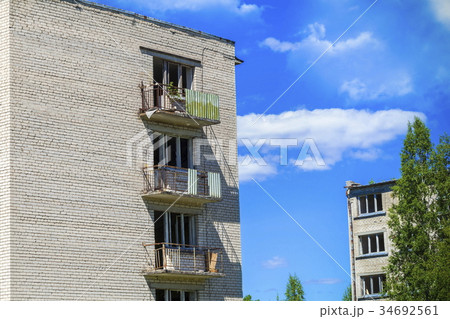 Abandoned old apartment houses on blue sky Abandoned old apartment houses on blue sky 34692561