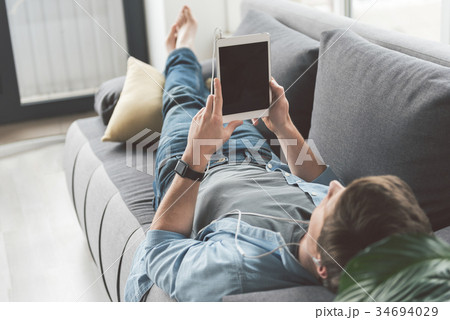 Man watching at electronic tablet 34694029
