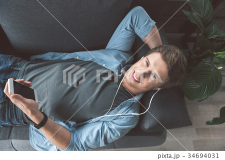 Happy man listening music at home 34694031