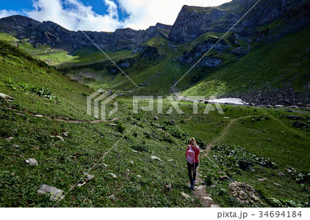 Woman traveler with backpack on beautiful mountain Woman traveler with backpack on beautiful mountain 34694184