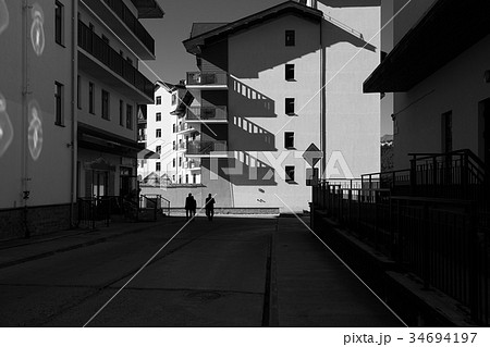 Black and white photo of city street with long 34694197