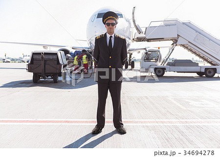 Serious airman locating near plane Serious airman locating near plane 34694278