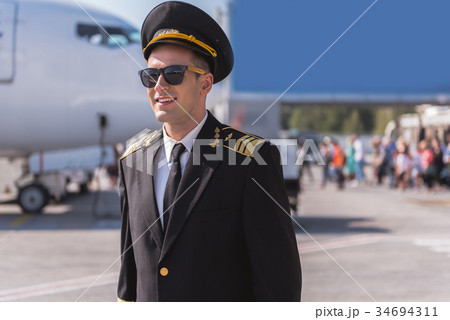 Hilarious airman near big plane 34694311