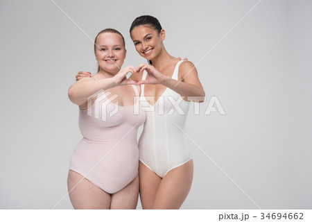 Happy fat and slim lesbian couple embracing with - Stock Photo 34694662