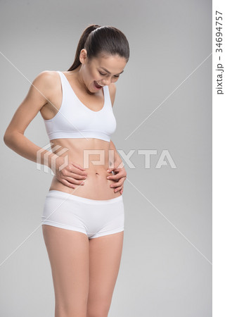 Cheerful fit girl is satisfied with her body Cheerful fit girl is satisfied with her body 34694757
