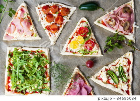 Pastry sandwiches with vegetables on baking paper Pastry sandwiches with vegetables on baking paper 34695034