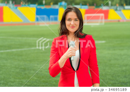 Young girl TV reporter is broadcasting 34695189
