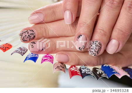 Female perfect nude patterned manicure. 34695328