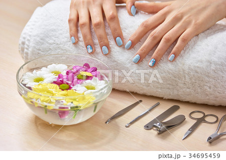 Female manicured hands on towel. Female manicured hands on towel. 34695459