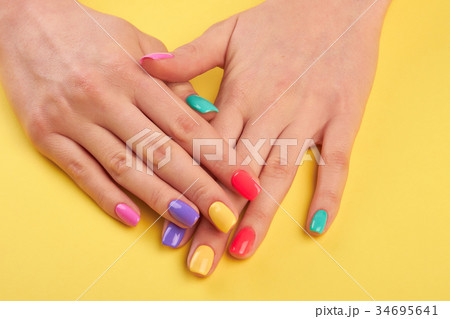 Woman nails painted in different colors. Woman nails painted in different colors. 34695641