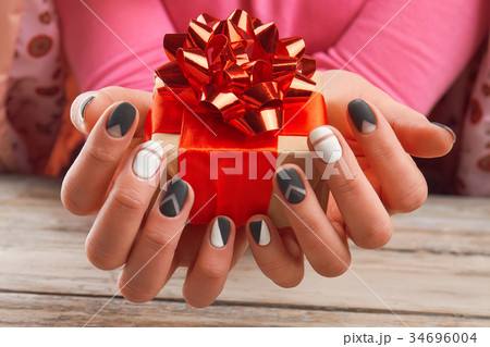 Handmade gift box in female hands. Handmade gift box in female hands. 34696004