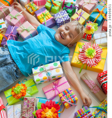 The child is littered with gifts. The child is littered with gifts. 34699851