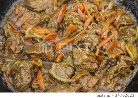 Pieces of meat are fried 34702022