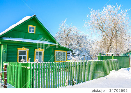 rural wooden house in winter covered with snow. rural wooden house in winter covered with snow. 34702692