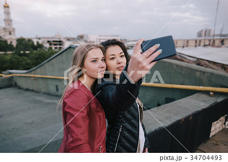 Selfie of two young girls on city background 34704493