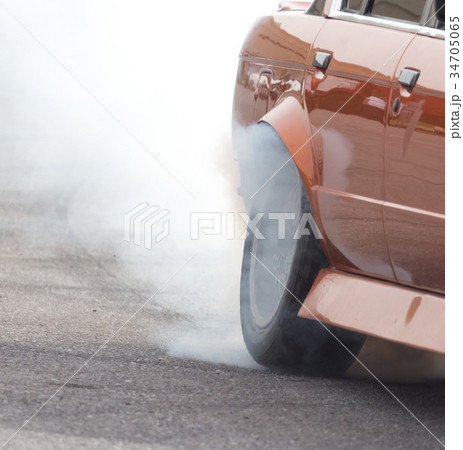 Smoke from under the wheels of the car Smoke from under the wheels of the car 34705065