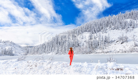 A young girl admires the winter landscape on the 34707368