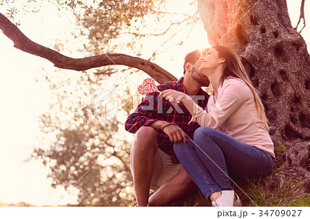 Young beautiful couple under tree in beautiful 34709027