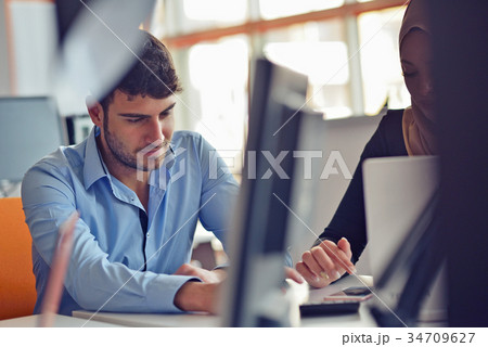 Freelance programmer working in startup office Freelance programmer working in startup office 34709627