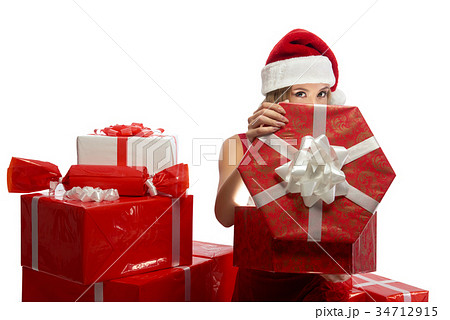 Young attractive female opening Christmas presents 34712915