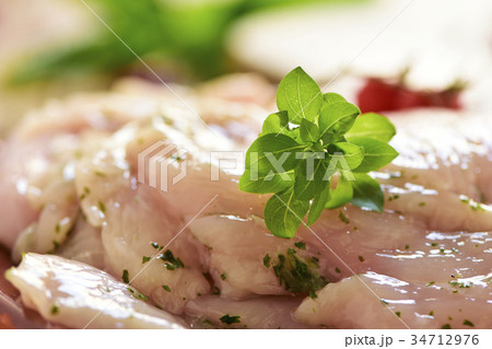 spiced raw slices of chicken breast 34712976