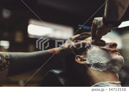 Barber shaving client 34713538