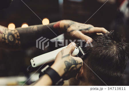 Barber shaving man in chair Barber shaving man in chair 34713611