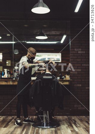 Stylish man working with client in salon 34713626