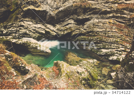 Rocks eroded by water from stream in autumn forest 34714122