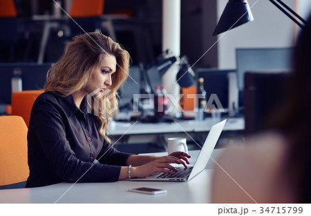 Portrait of smiling pretty young business woman Portrait of smiling pretty young business woman 34715799
