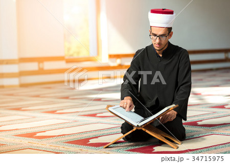 Religious muslim man praying inside the mosque 34715975