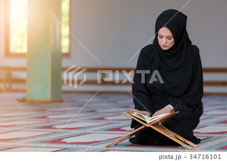 Young muslim woman praying in mosque 34716101