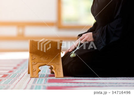 Young muslim woman praying in mosque 34716496