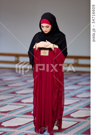 Young muslim woman praying in mosque 34716609